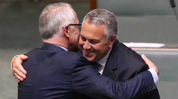 Prime Minister Turnbull embraces Treasurer Joe Hockey after his valedictory speech.