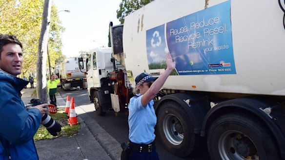 Police guide garbage trucks from Blacktown during the May 2015 protest against the SBS show <i>Struggle Street</i>, before the first episode aired.