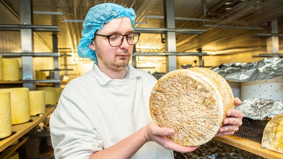 Chef-turned-cheesemaker Michael Paradise with a wheel of aged blue.