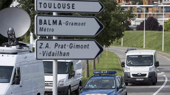 French gendarmes escort a van (right) transporting the debris found on Reunion Island to a military-run office for analysis.