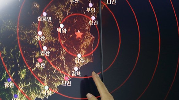 An official at Seoul's Earthquake and Volcano Monitoring Division points at the epicentre of seismic waves in North Korea.