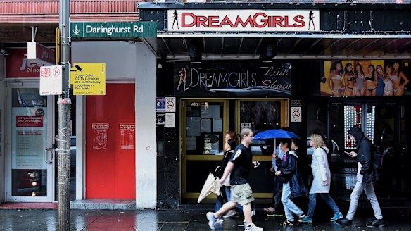 People walk past the entrance to DreamGirls on Darlinghurst Road in Kings Cross, Sydney. 