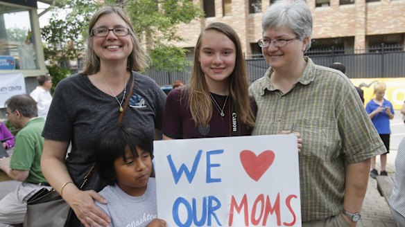 Beth Sherman (left) and her wife Karen Hawver (right) celebrate with their children Ben and Emma (centre) the US Supreme Court's landmark ruling of legalising gay marriage nationwide, at a rally in Ann Arbor, Michigan.