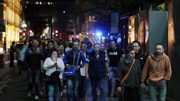 Members of the public are led away from the scene near London Bridge.