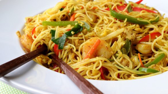 Curry powder gives Singapore noodles its signature golden colour.