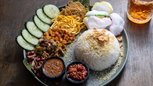 Nasi uduk - an Indonesian spin on the Nasi Lemak - with fried rice noodles, shredded chicken, crunchy anchovies and peanuts, fried chilli potato, spiced omelette, cucumber, crackers, peanut
sauce, sambal, coconut rice and fried shallots.