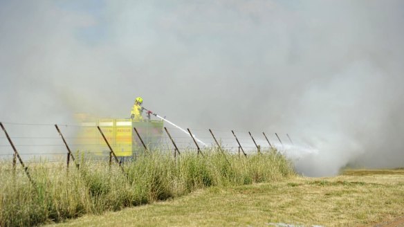 Fire crews put out a small grass fire on majura road near the airport in November 2014. 
