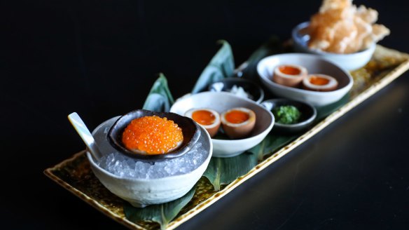 Chuuka's roe service with house-marinated trout roe, cashew cream, shallots, chives, tea eggs and potato rice crackers.