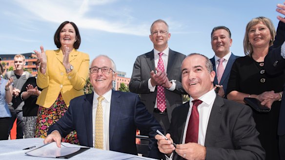 Prime Minister Malcolm Turnbull (centre) and Acting Victorian Premier James Merlino in Corangamite on Wednesday. 
