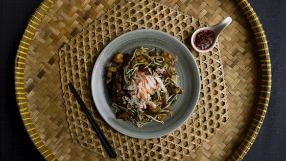 The char kwai teow with crab meat also includes wads of salty, oil-slicked noodles tossed with prawns, chives, crunchy bean sprouts. 
