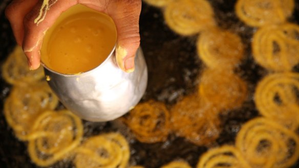 Swirls of batter are deep-fried then soaked in sugar syrup to make jalebi.