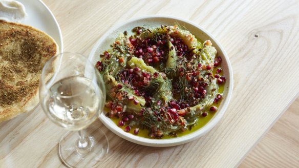 Chopped eggplant, pomegranate and toasted olive seeds.