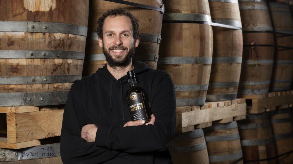 Adelaide Hills Distillery founder Sacha la Forgia with a bottle of his award-winning Native Grain Weeping Grass Whiskey.