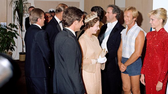 Queen Elizabeth II and the Duke of Edinburgh meet Australian entertainers who performed in a Royal Charity Concert at the Sydney Opera House. Performers include from left pianist Roger Woodward, comedian Paul Hogan and singer Olivia Newton-John. 