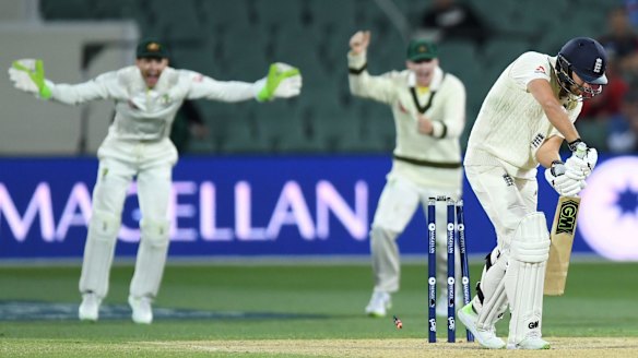 Straight through: Malan is clean bowled by Cummins.