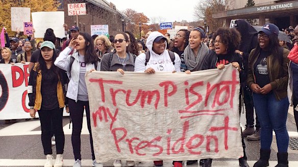 People protest on the University of Connecticut campus against the election of Republican Donald Trump as President.