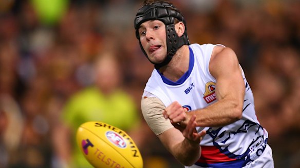 Caleb Daniel of the Bulldogs handballs during the Dogs' win.
