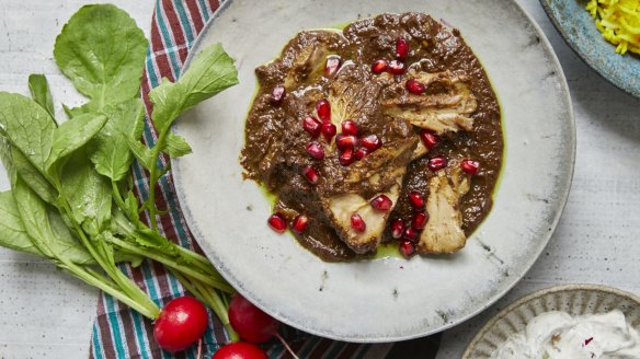 Khoresh-e fesenjoon, or Persian chicken stew with pomegranate and walnuts, in New York, April 25, 2019. The dish hails from the verdant northern Iranian hills and coast, where pomegranate and walnut trees both grow. Food Stylist: Simon Andrews. Prop Stylist: Paige Hicks. (Con Poulos/The New York Times)
 Persian chicken stew with pomegranates and walnuts by Samin Nosrat.