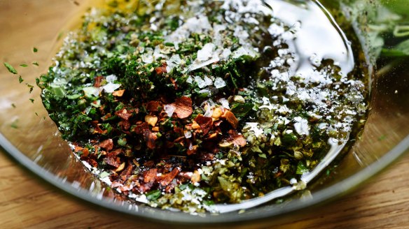 The makings of chimichurri, which includes parsley, oregano, garlic, olive oil, salt, pepper and crushed red pepper.