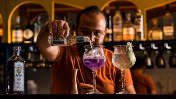 Co-owner Gaurang Gahoi with pea flower gin and tonic, and betel leaf gin and tonic. 