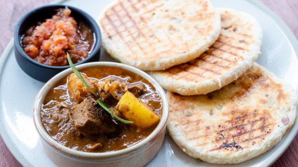 The village pol roti with beef and potato curry is served with freshly grilled coconut flatbread. 
