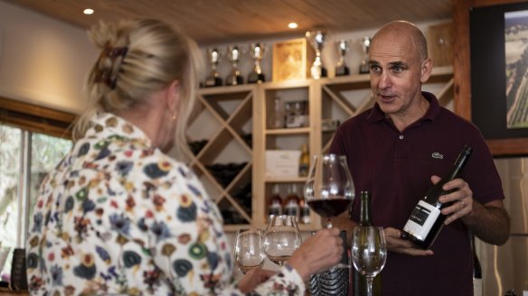 Rowan Addison from Tertini wines cellar door pours a pinot noir tasting for visitors.