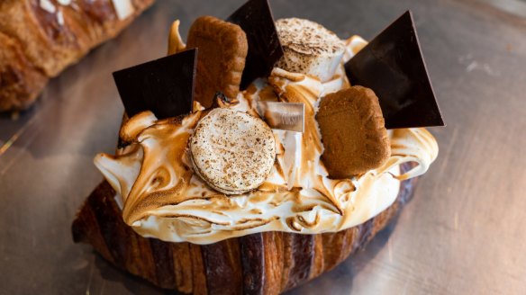 A close-up of the s'mores croissant, with torched marshmallows, chocolate shards and Lotus biscuits.