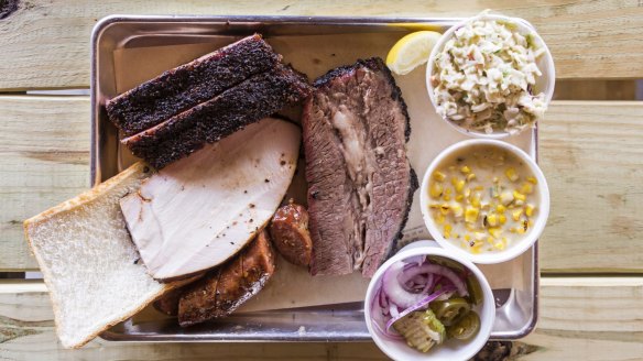 Beef brisket, turkey and hot link with creamed corn, jalapeno coleslaw and cucumber salad at Blood Bros.
