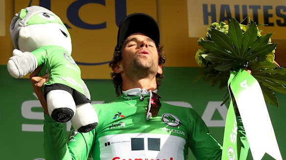 Michael Matthews celebrates on the podium after taking the green jersey.