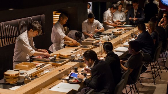 Chefs working behind the sushi bar at Kisume.