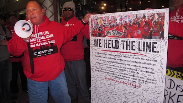 Marc Scittina, a worker at the Trump Taj Mahal casino in Atlantic City, addresses strikers who signed a poster critical of billionaire Carl Icahn, who owns the recently closed casino.