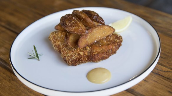 Ham and cheese stuffed pork cotoletta with potato wedges.