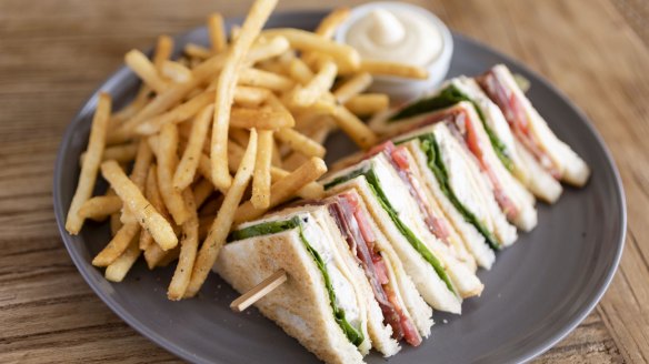 A nod to the past: Truffled chicken club sandwich with fries.