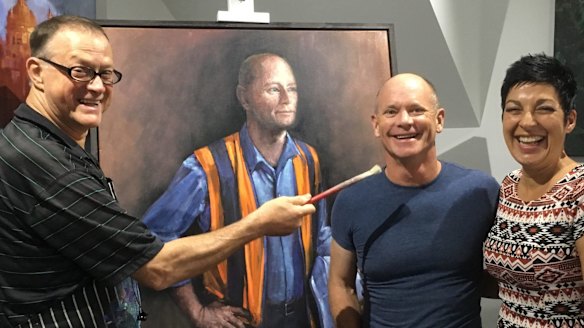 David Hinchliffe in his studio with Campbell and Lisa Newman and his portrait of the former premier.