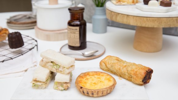 T Totaler tea (at rear) and savoury pastries (from left to right: Rockpool finger sandwiches, Flour and Stone quiche, Bourke Street Bakery sausage roll).