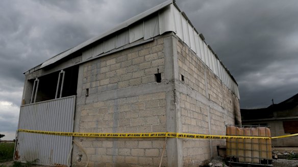 A police cordon is seen at a warehouse where a tunnel, connected to the Altiplano Federal Penitentiary and used by drug lord Joaquin 'El Chapo' Guzman to escape, ended.