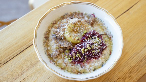 Porridge served with saffron-spiced poached pears, rhubarb jam and a dusting of coconut.
