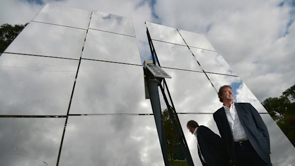 John Lasich, chief technology officer at RayGen, stands in front of mirrors used to concentrate sunlight onto a highly efficient solar receiver to produce electricity under the Victorian-based project.