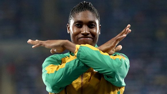 Caster Semenya brushes  the dust off her shoulders after the race.