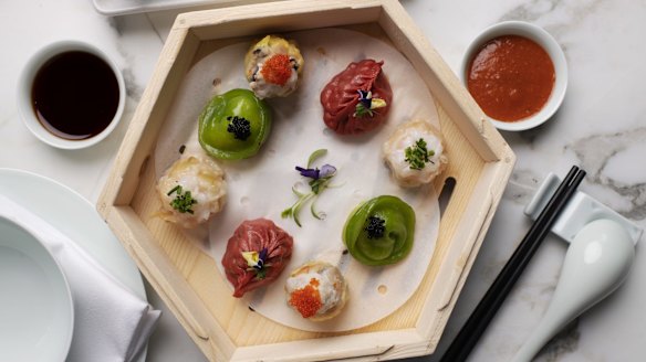 Assorted dim sum in a hexagonal steamer basket.