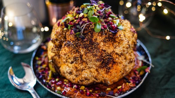 Christmas centrepiece: Whole-roasted spice-rubbed cauliflower sitting on romesco.