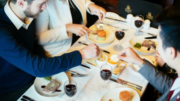 Tucking into entrees and free-flowing shiraz aboard the tram.