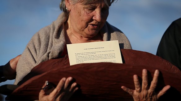 Pat Anderson from the Referendum Council holds the Uluru statement during the convention's closing ceremony.