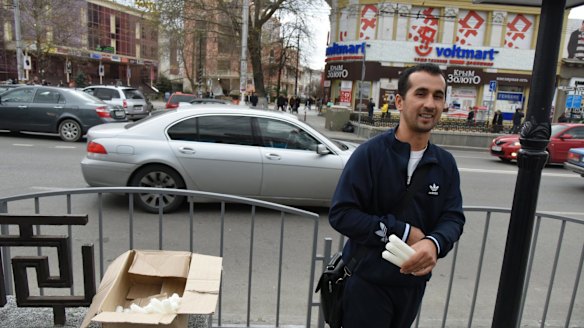 A man sells candles on a street after a power failure in Simferopol, Crimea.
