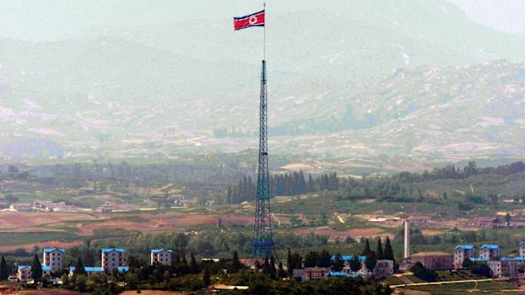 A giant North Korean flag flutters on the top of a tower in North Korea seen from the Demilitarised Zone near the border village of Panmunjom.