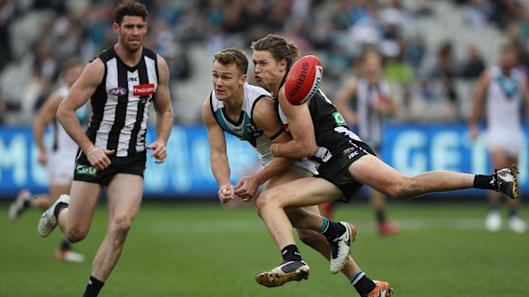 Port's Robbie Gray is tackled by Magpie Tom Langdon, but proved a handful all day.