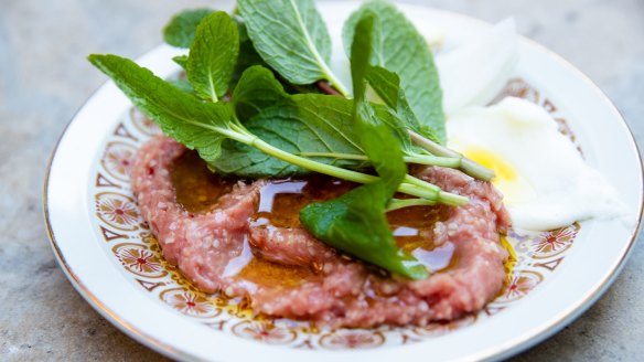 Kibbe nayeh, a pounded spread of raw beef, onion, burghul and dark, sweet spices. 