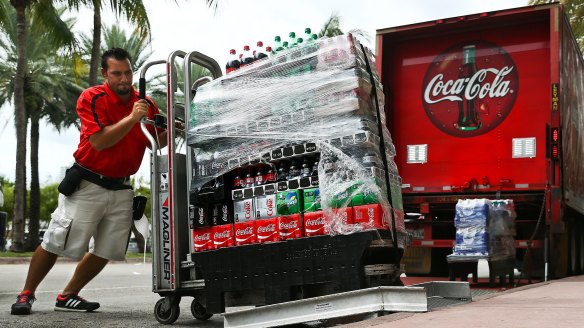 An employee delivers cases of Coca-Cola in Miami Beach, Florida.