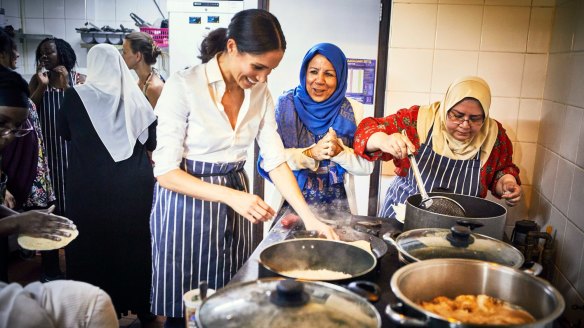 Meghan Markle, the Duchess of Sussex, cooks with women in the Hubb Community Kitchen in London.