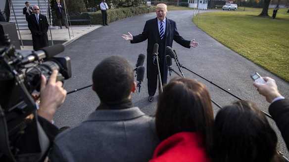 US President Donald Trump speaks to members of the media following the passage of the tax-cut bill through the Senate.